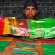 Man holding up row of multicolored Fruit Roll Ups